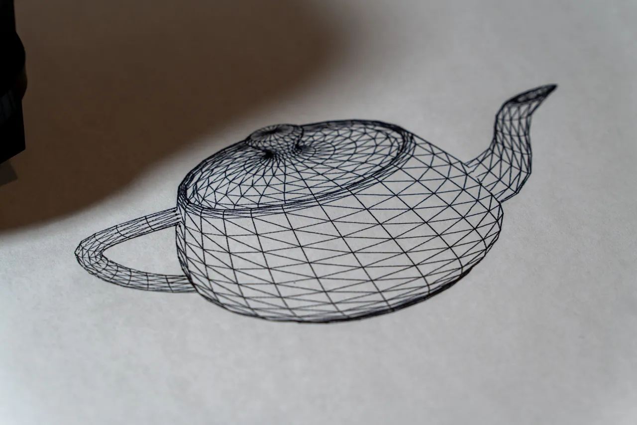 Utah teapot wireframe drawn in pen on paper by a converted 3D printer